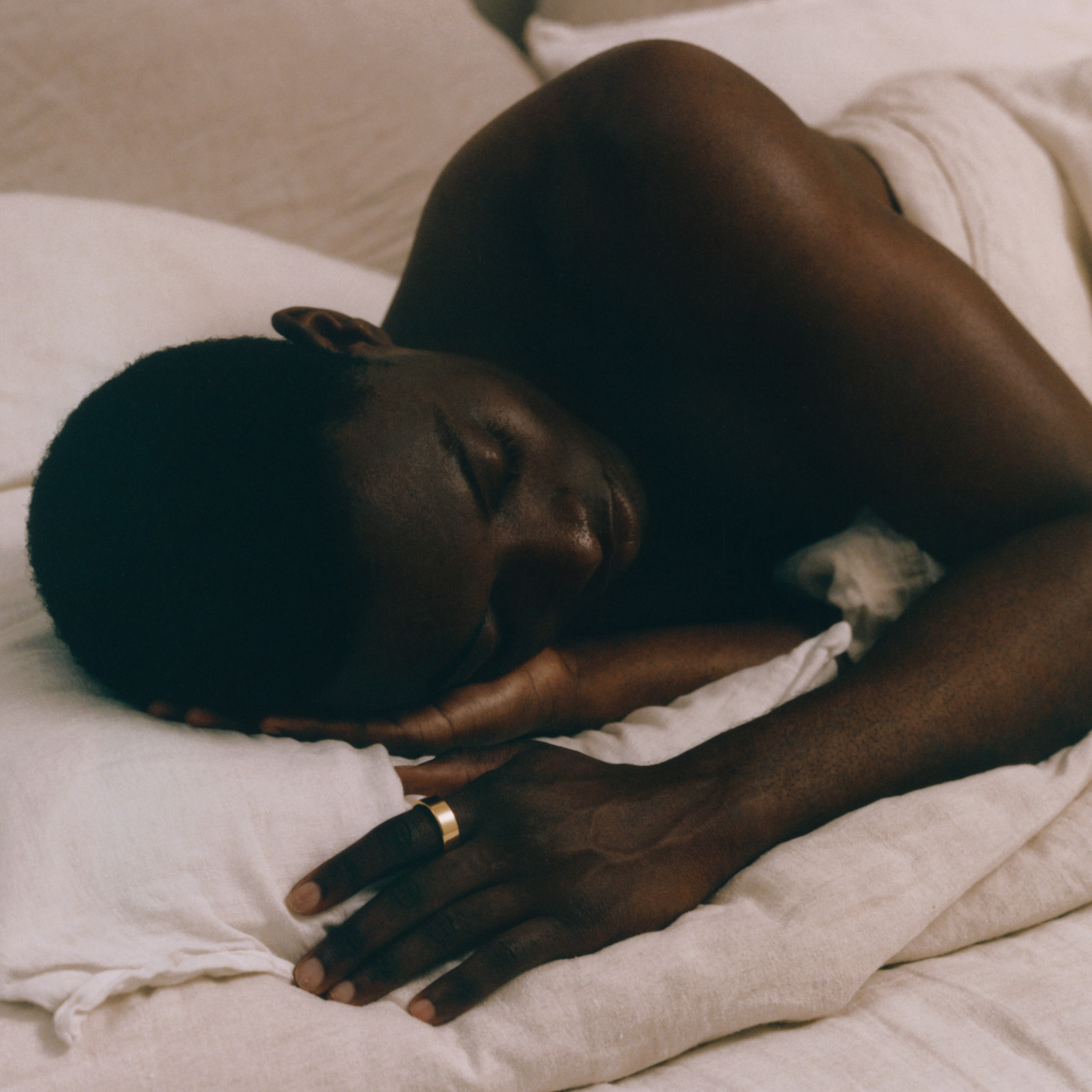 Person lying in bed with a soft focus background